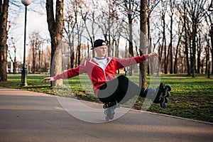 Roller skater doing balance exercise on sidewalk