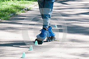 Roller skates on female legs close up. The girl deftly drives around the chips