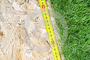 Roller tape lying on the artificial turf roll lying on the osb subfloor. photo
