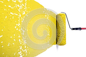Roller With Yellow Paint on White Wall