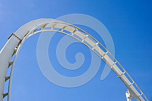 Rollercoaster Ride and loop against blue sky
