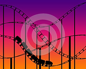 Rollercoaster silhouette on sunset sky background