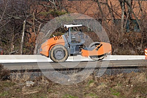 rollers rolling fresh hot asphalt on the new road road construction