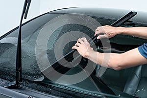 Rolling car window film on front windscreen glass surface