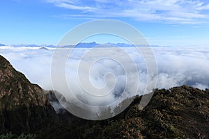 Rolling clouds and frozen mountain summits sunrise landscape photo