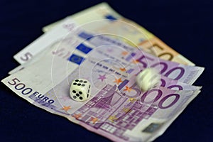Rolling dice on sorted Euro banknotes