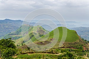 Rolling fertile hills with fields and crops on Ring Road of Cameroon, Africa