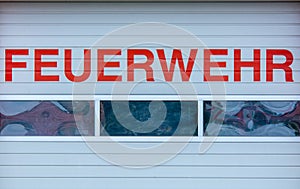 Rolling gate of a fire station with the words `fire department` in German