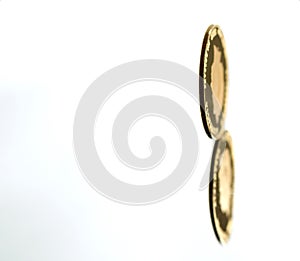 Rolling gold coin with reflection