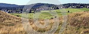 rolling grassy hills and houses in french jura