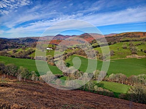 Rolling hills with trees and fields in the Welsh countryside