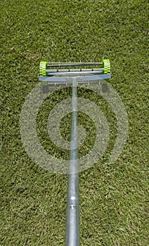 Rolling lawn aerator lawn in action