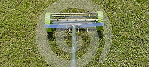 Rolling lawn aerator lawn in action