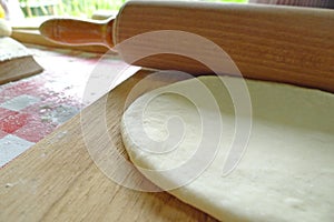 Rolling pin and dough to make bread