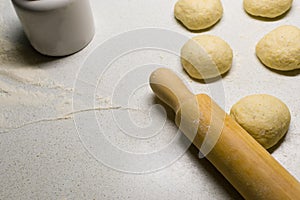 Rolling pin and dough on white kitchen working table, copy space