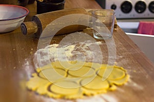 Rolling pin, glass, flour and dough to prepare sopaipillas photo