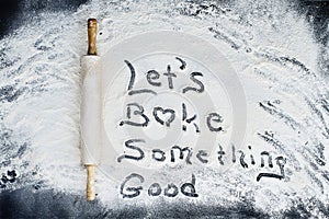 Rolling Pin Over Flour Background with Writing