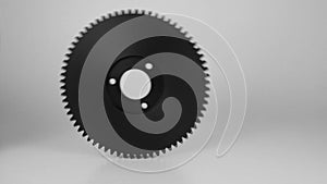 Rolling plastic gears in white and black, isolated on a white background.