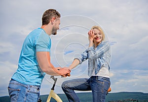 Rolling romance or bike date. asual acquaintance concept. Man with beard and shy blonde girl on first date. Woman feels