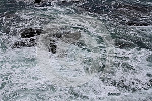 Rolling sea waves slamming on rocks photo