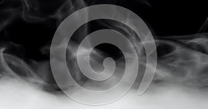 Rolling smoke clouds or swirling fog with wisps of vapor on black