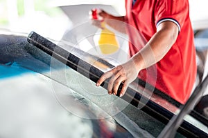 Rolling and spraying car film on front windscreen glass