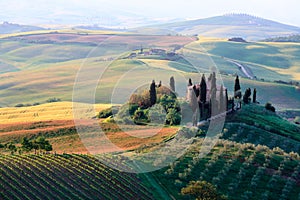 Rolling Tuscan hills and farmhouse photo