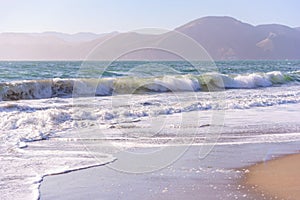 Rolling Waves and sand at Baker Beach San Francisco California photo
