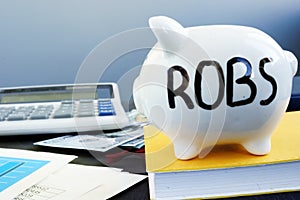 Rollover for Business Startups ROBS written on a piggy bank. photo