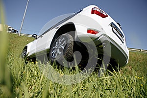 Rollover Compact Car Crash. White Crashed Car in the Mountain Road Ditch in California, USA. Traffic Accident.