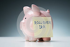 Rollover Ira Text On Note With Piggy Bank