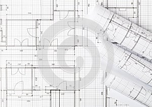 Rolls of architectural blueprint house building plans on blueprint background flat lay