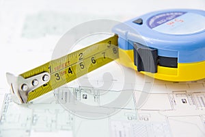 Rolls of architectural house plans & tape measure