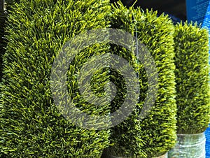 Rolls of artificial Grass Turf Mat for sale at a hardware store