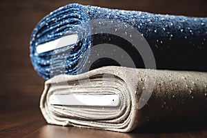 Rolls of blue and brown fabric on wooden