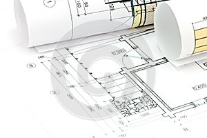 Rolls of blueprints with architectural plans and technical drawings closeup