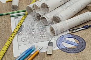 Rolls of blueprints on wooden table