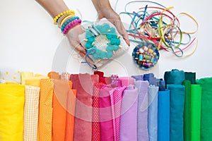 Rolls of bright colored fabric on a white background.