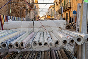 Rolls of cloth displayed at a street martket