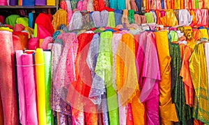 Rolls colorful of brightly coloured fabrics and cloths store