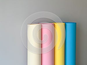 Rolls of colourful paper on a simple background