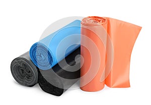 Rolls of different color garbage bags isolated on white