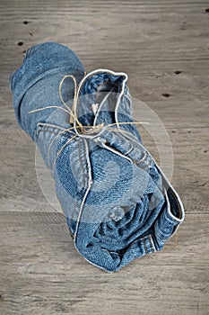 Rolls of different worn blue jeans stacked