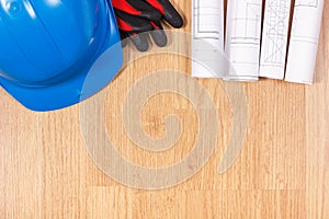 Rolls of electrical drawings, protective blue helmet and gloves, accessories for engineer jobs