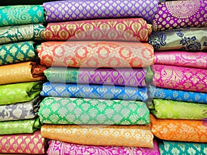 Rolls of fabric and textiles in shop. Multi colors indian patterns on the market Fabrics in rolls. Fabric store in Pune,