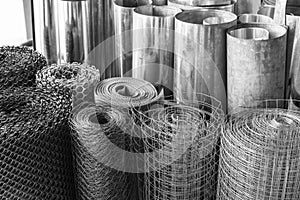 Rolls of galvanized metal sheets, steel chicken wire mesh, and p