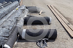 Rolls of geogrid for reinforcement the roadbed. photo