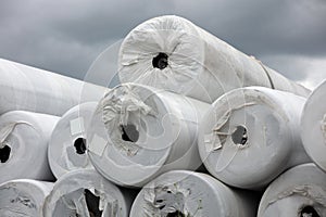 rolls of geotextile membrane stacked and packaged in white plastic photo