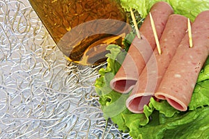 Rolls of ham on lettuce