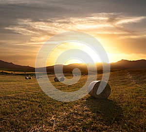 Rolls Of Hay At The Sunset